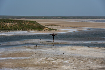 Fototapeta na wymiar landscape of the Baskunchak salt lake with infrastructure for salt extraction on a sunny spring day