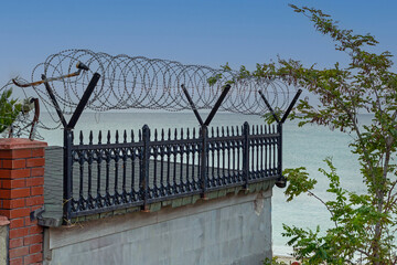 Metal razor wire safety fence outside house property - 795627448