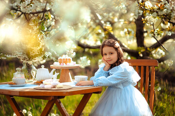 a beautiful girl in a delicate blue dress on a picnic had a tea 