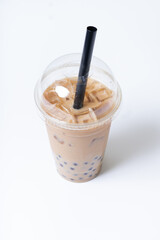 Plastic glass with bubble tea and ice. Trendy summer drink on white background