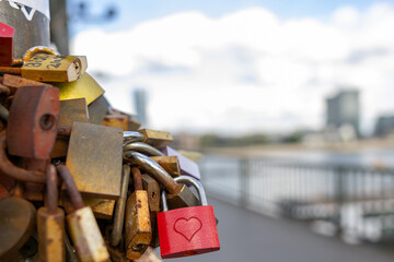 Many love locks on a publice bridge with the sky in the background