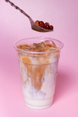 Process preparing bubble tea with milk and coffee. Trendy summer drink