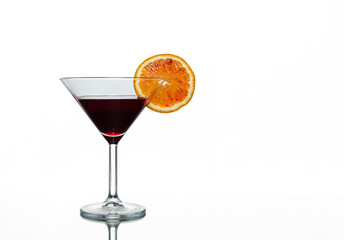 Dark purple drink in cocktail glass with slice of blood orange isolated on white background
