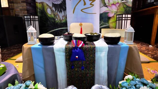 Traditional Korean Wedding Table Setup With Symbolic Items and Decorations.A detailed view of a ceremonial table adorned with various symbolic items used in a traditional Korean wedding, showcasing cu