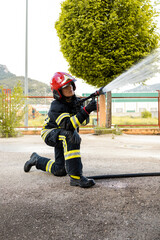 A senior Caucasian woman works as a firefighter dressed in a uniform.The adult woman is on her...