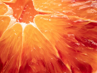 Red blood orange fruit slice, extreme close-up.
