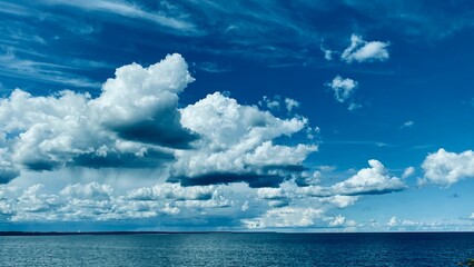 View of the sea and blue sky with white clouds. Summer photo landscape.