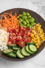 poke bowl with fresh cucumbers, carrots, edamame beans, corn, rice and sesame seeds, Bowl of healthy food on white background