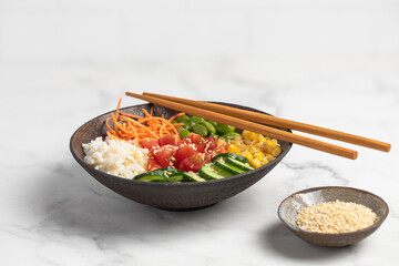 poke bowl with fresh cucumbers, carrots, edamame beans, corn, rice and sesame seeds, Bowl of healthy food on white background