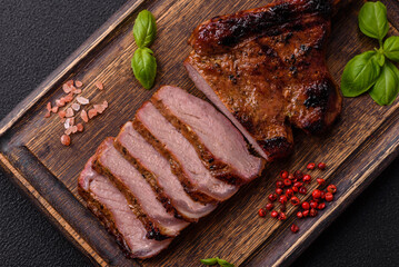 Delicious juicy beef steak on the bone, tomahawk with salt, spices and herbs