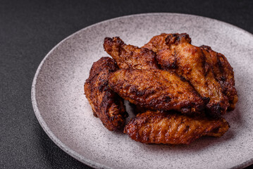 Delicious juicy chicken wings baked on the grill with salt, spices and herbs