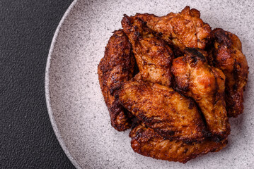 Delicious juicy chicken wings baked on the grill with salt, spices and herbs