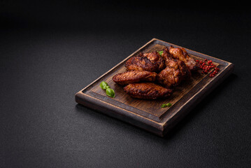 Delicious juicy chicken wings baked on the grill with salt, spices and herbs