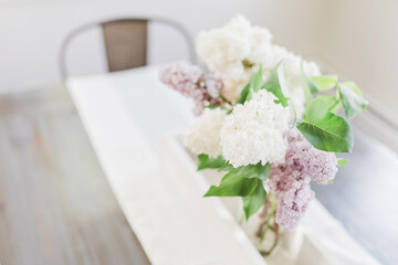 white and purple lilacs in a vase
