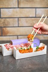 Sushi roll Philadelphia with salmon, smoked eel, avocado, cream cheese on black background. Sushi menu. Japanese food.