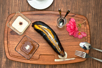 Dessert bananas, roasted banana opened in half and bathed with condensed milk accompanied with cappuccino coffee