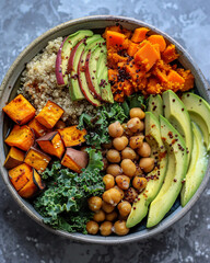 the beauty of a vegan Buddha bowl: a colorful assortment of ingredients such as quinoa, roasted sweet potatoes, avocado slices, chickpeas, and kale, arranged in a visually pattern on a ceramic plate