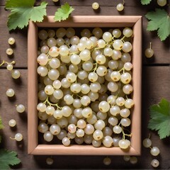 Fresh white currant in box on wooden table background. Top view