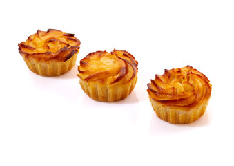 Delicate vanilla sweets lled with buttercream and candied citrus fruits topped with nut crumbs and yellow icing, presented isolated on white background