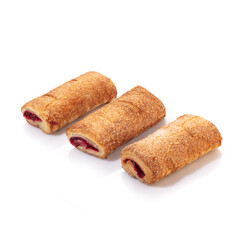 Delicate vanilla sponge rolls filled with buttercream and candied citrus fruits topped with nut crumbs and yellow icing, presented isolated on white background