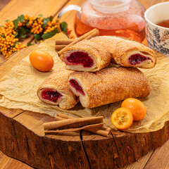 Delicate crispy meringue sandwiches with lush fig cream filling, presented on rustic wooden board amidst warmth of tea setting. Moment of cozy enjoyment of teatime with sweet treats