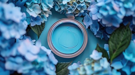 Top-down view of an open paint can in Serenity, a soft blue shade, surrounded by blue hydrangeas...