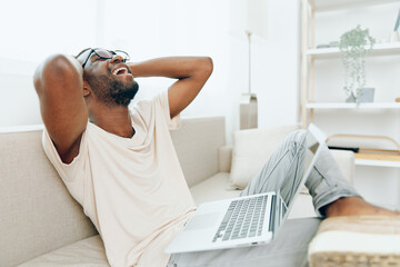 Smiling African American Freelancer Working on Laptop in Modern Home Office