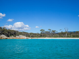 Turquoise waters, red lichen covered rocks and bush of the Bay of Fires, Tasmania