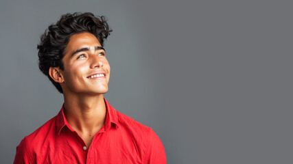 Fototapeta premium Side view candid of hispanic businessman in red shirt smiling isolated