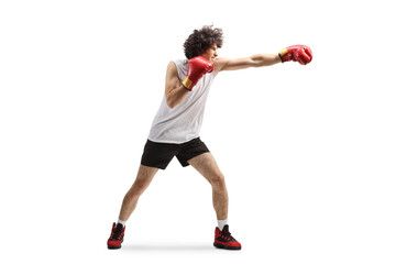 Young man punching with boxing gloves