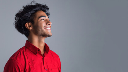 Obraz premium Side candid view of Indian businessman in red shirt smiling isolated