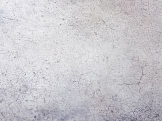 A close-up of a weathered concrete wall with a smooth, gray surface.