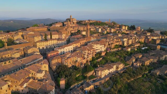Aerial sunrise view of Montalcino old town, Italy. Flying early in the morning over Montalcino medieval Italian town, Tuscany