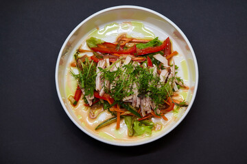 A white plate with a vegetable salad, a staple food on the table