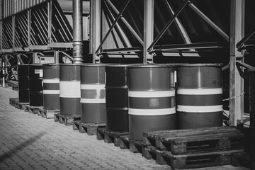 many oil drums are standing next to each other on pallets