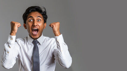 Indian businessman in white shirt raised fist with surprise face - Powered by Adobe