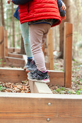 Walking on a log in the forest. Motor movement concept in nature. Balance exercise. Kind läuft auf...