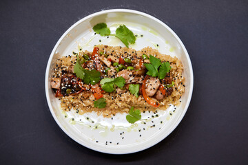 A plate of rice and vegetables on a table, a staple food dishware in cuisine