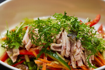 A white plate with a vegetable salad, a staple food on the table