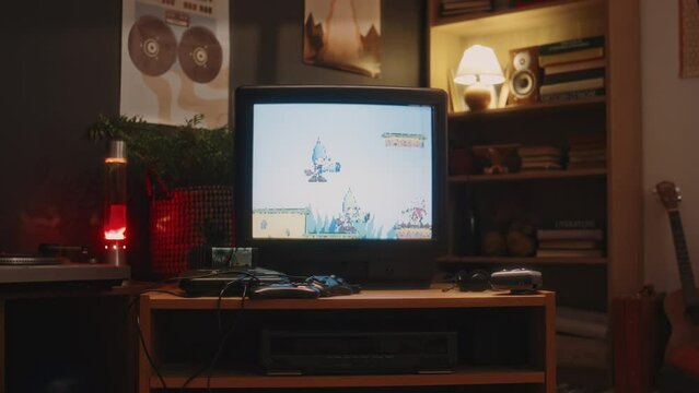 No people handheld footage of tube TV with old arcade video game with jumping dogs on screen at retro-styled room with soft light, nostalgic 90s
