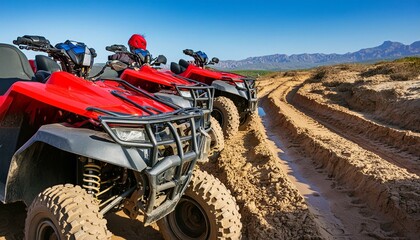 A row of red ATV quads parked along the muddy course in the desert - Powered by Adobe