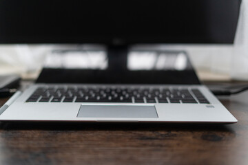Close up of a laptop on a wooden table in a home office