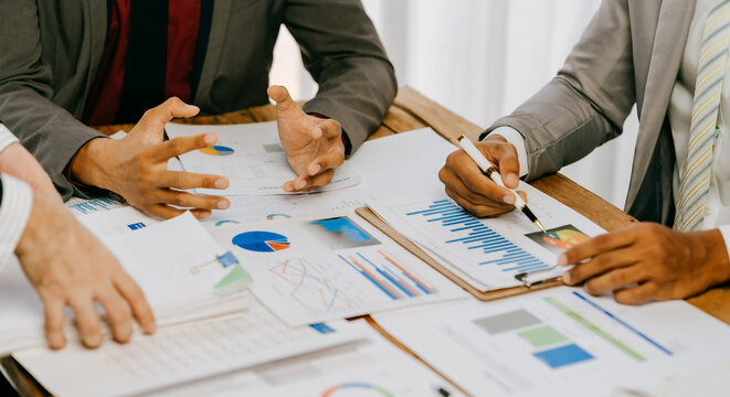 business people or accountant using calculator while working analytical business report on the workplace, accounting concept, Serious and focused financier accountant on paper work inside office,