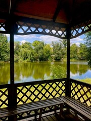 Cozy gazebo on the river bank on a warm summer day