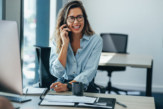 Woman talking on the phone in her business office