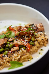 A plate of rice and vegetables on a table, a staple food dishware in cuisine