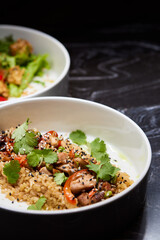 Close up of three bowls with fish ball, leaf vegetable, and plate on table