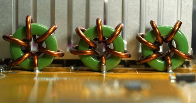 Elements of personal computer motherboard. Toroidal wire wound coils high current magnetic inductor. High current toroidal wound coils