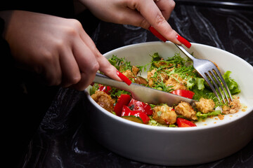 White bowl with lettuce, tomatoes, and chicken salad