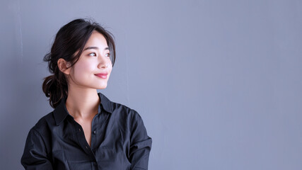 Side view of Asian businesswoman wearing black shirt, smiling candid